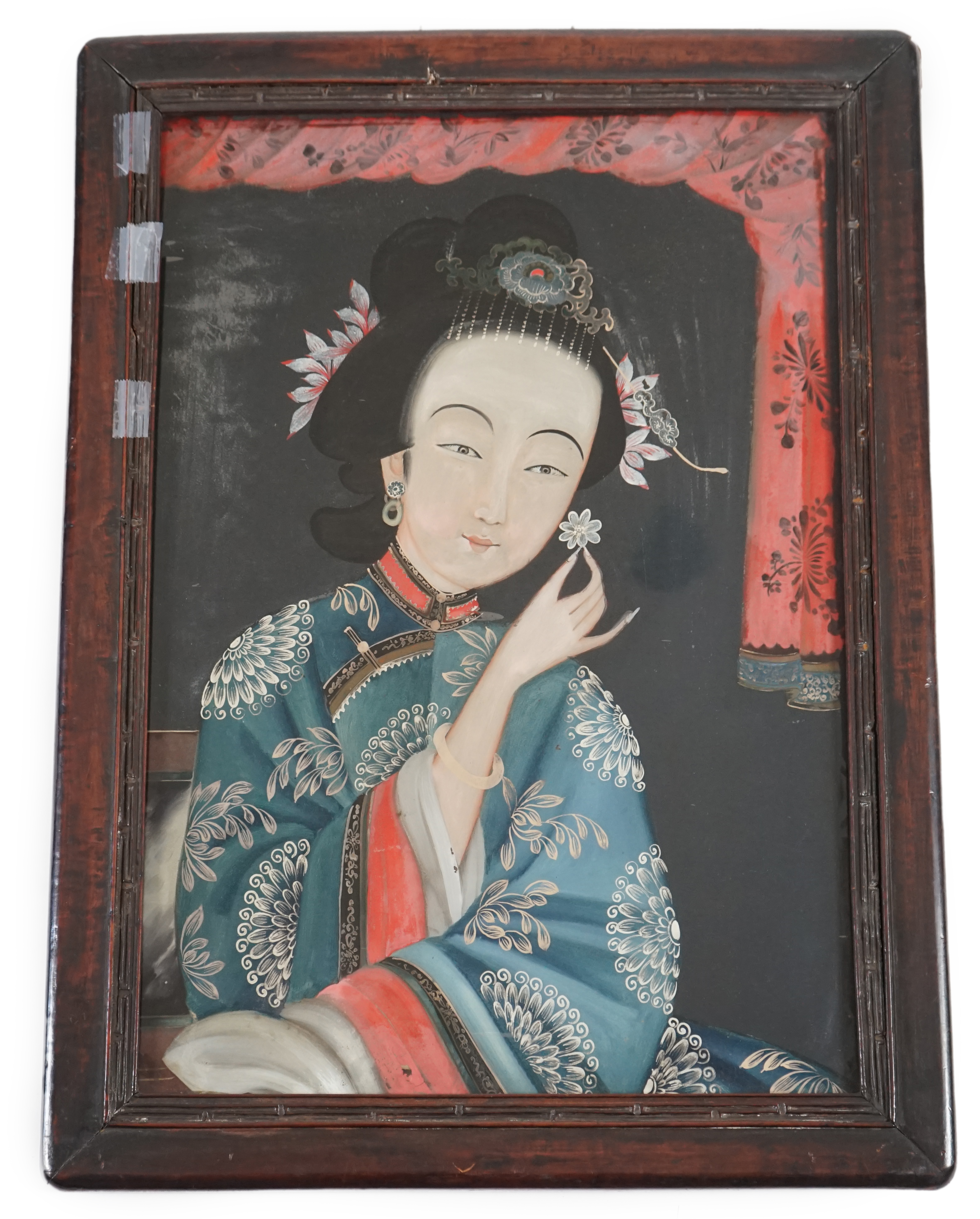 A Chinese reverse painting on glass of a lady holding a flower, 19th century